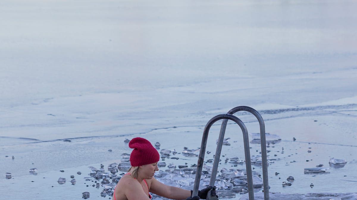 Person immersed in icy cold water for cold plunge recovery therapy