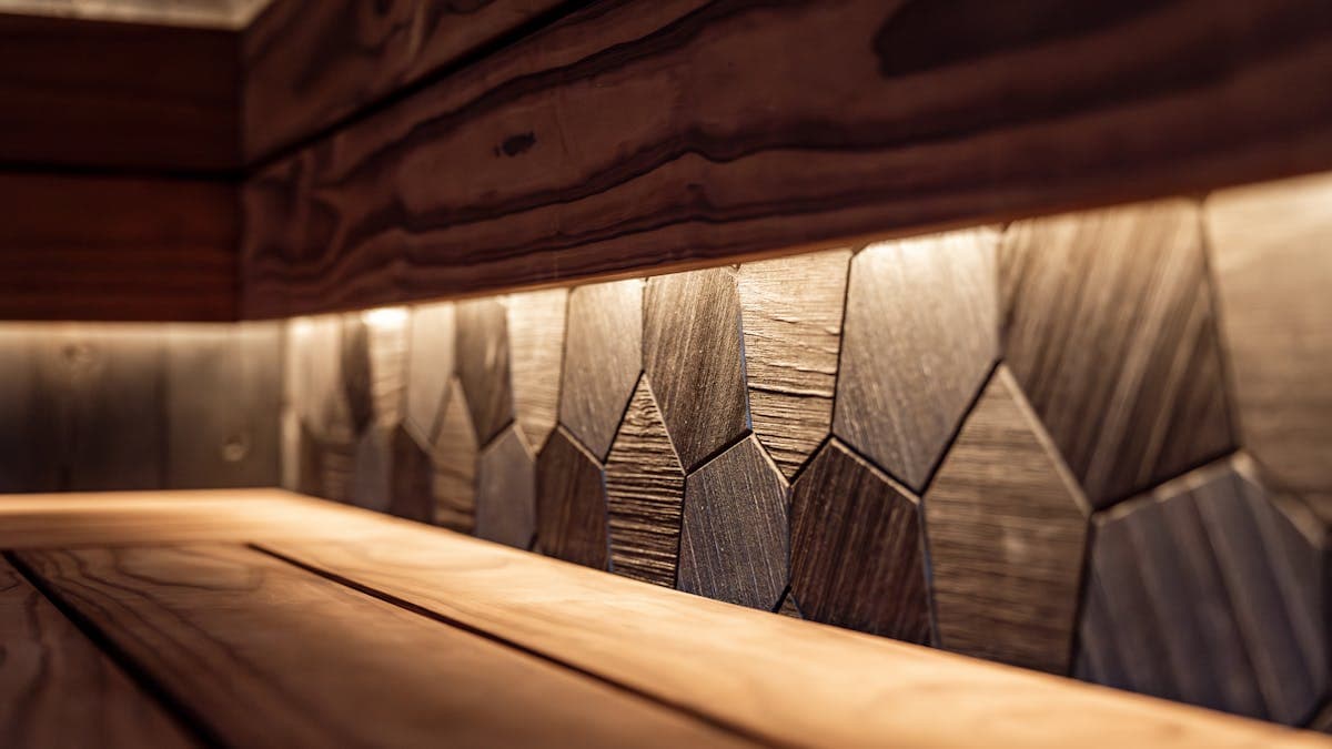 Outdoor cedar barrel sauna in a backyard garden setting — traditional Finnish steam experience at home